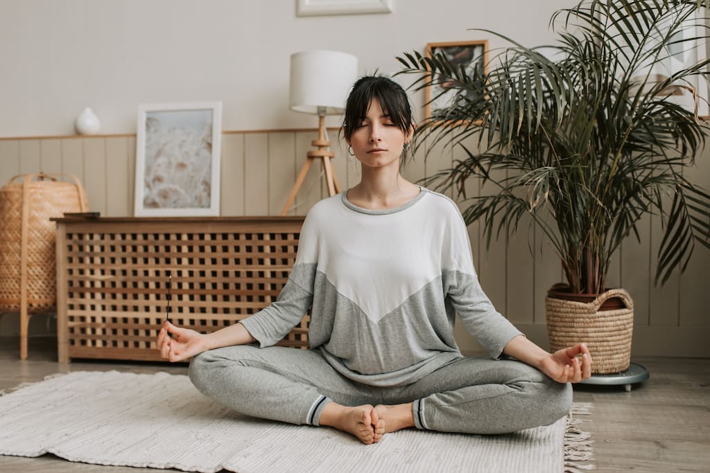 woman meditating in home