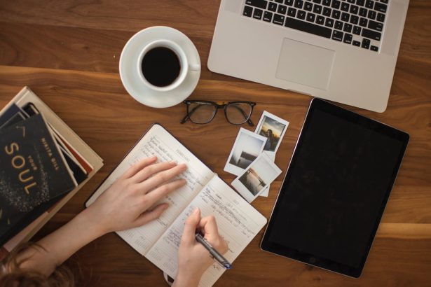 image of a perosn writing on a notebook, evoking the planning of changes in the wellness landscape at work