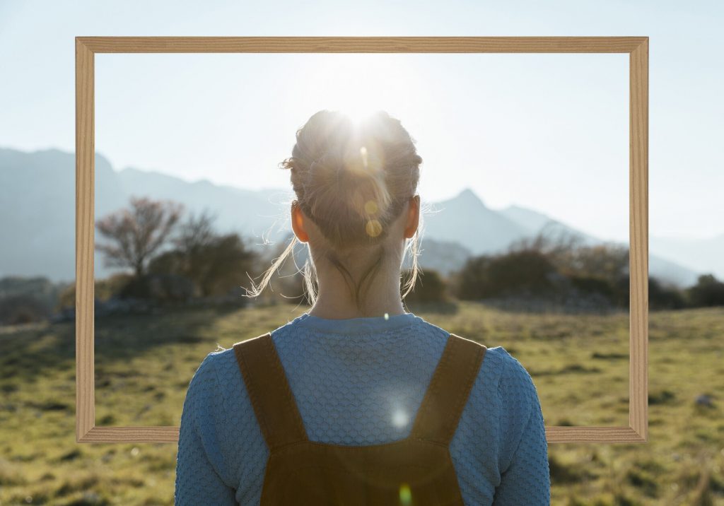 image of a woman looking to a mountain, evoking the thought of redifing body positivity