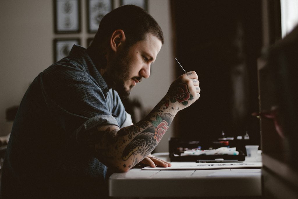 focused man with tattoo