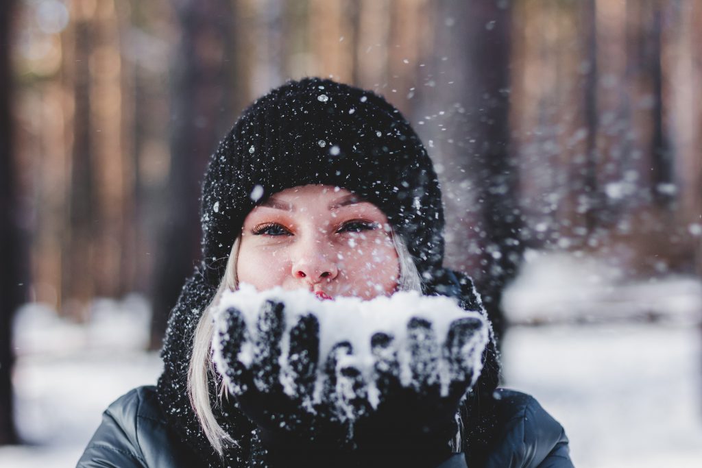 woman playing with snow