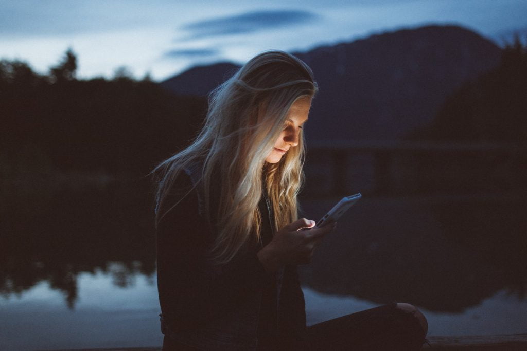 woman looking at her smartphone outside