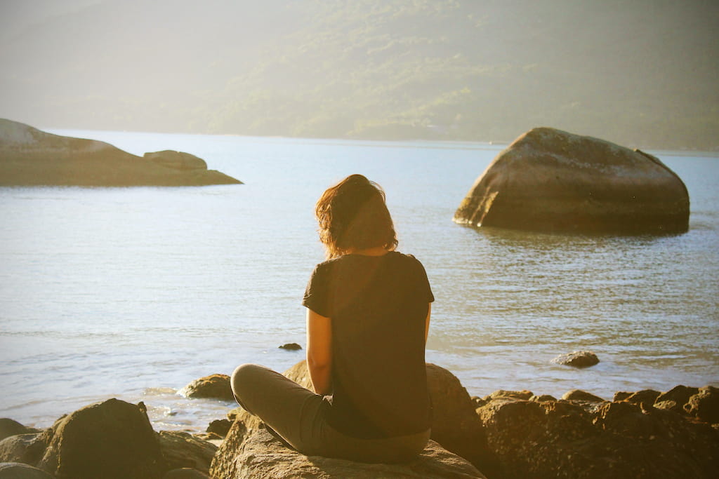 woman sitting on seaside