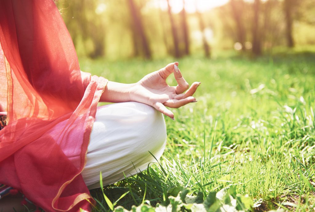 woman meditating in the garden