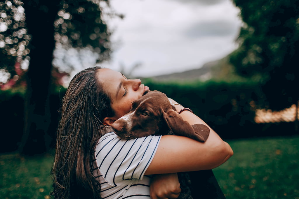 girl hugs her dog