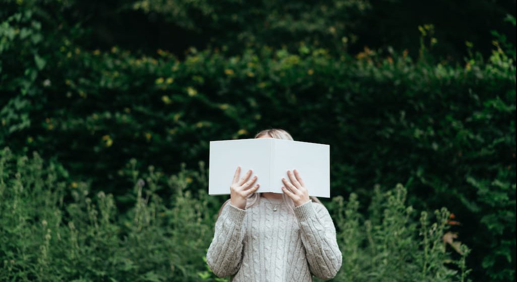 woman covering her face, evoking the feeling of social anxiety