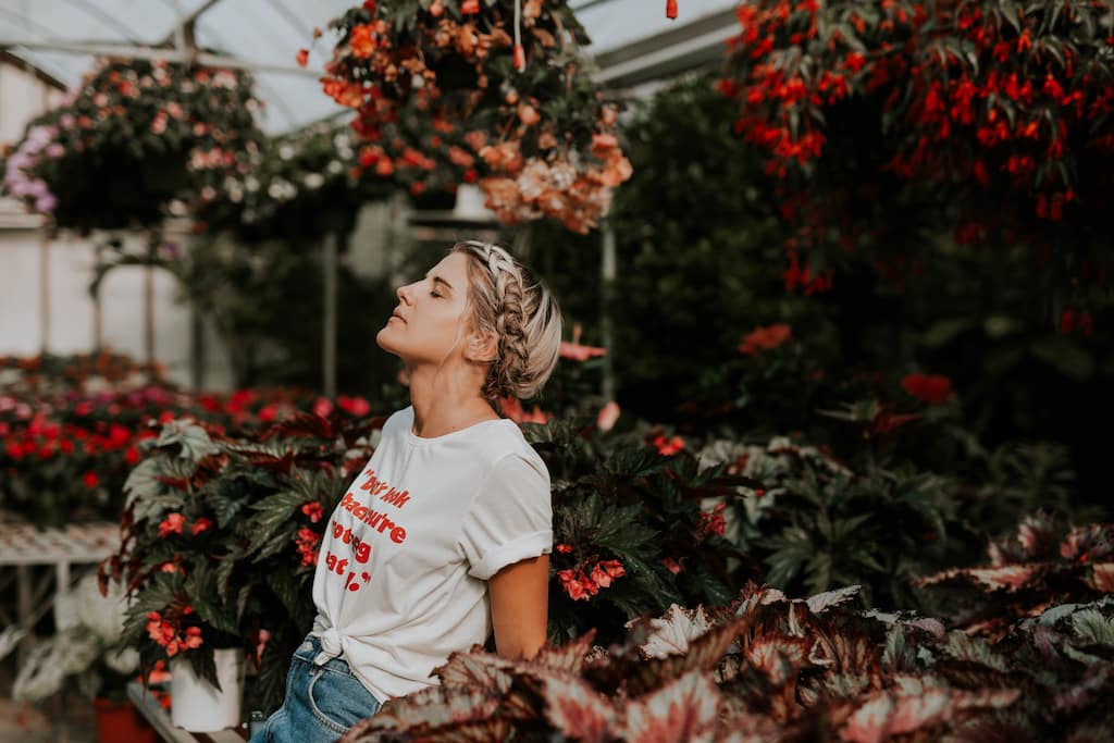 women breathing near flowers