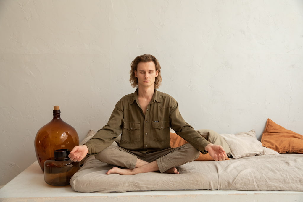 man meditating in a room