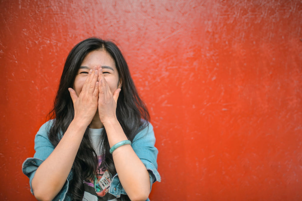 smiling happy woman with red background