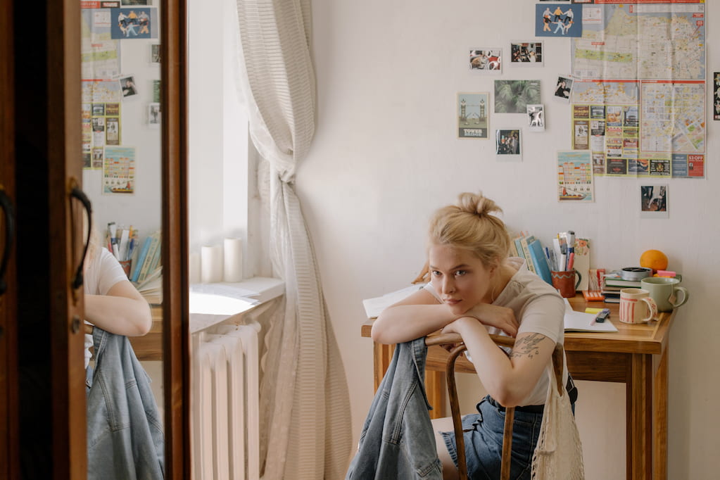 thoughtful woman sitting on a chair in the room