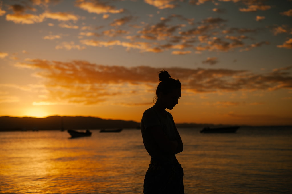 unhappy woman in sunset