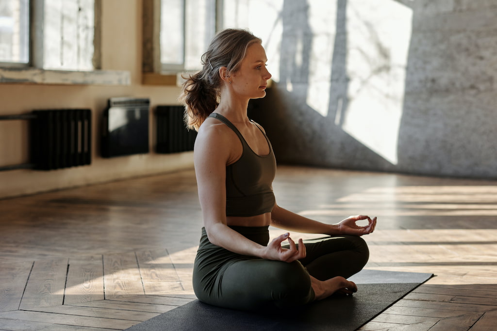blonde woman sitting and meditating
