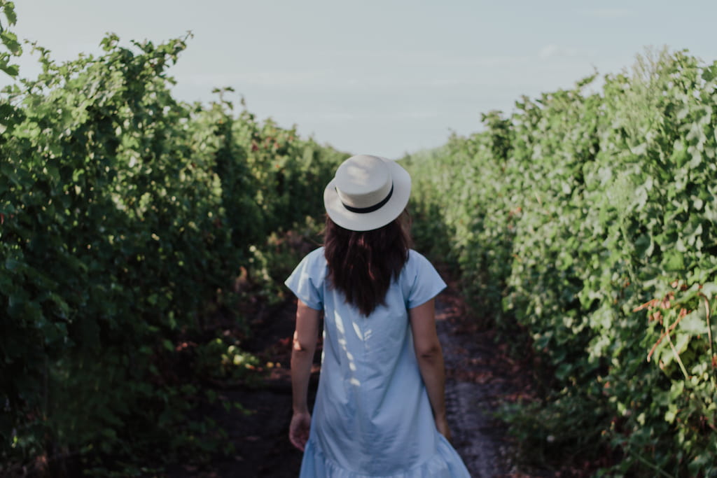 woman with hat walking in nature