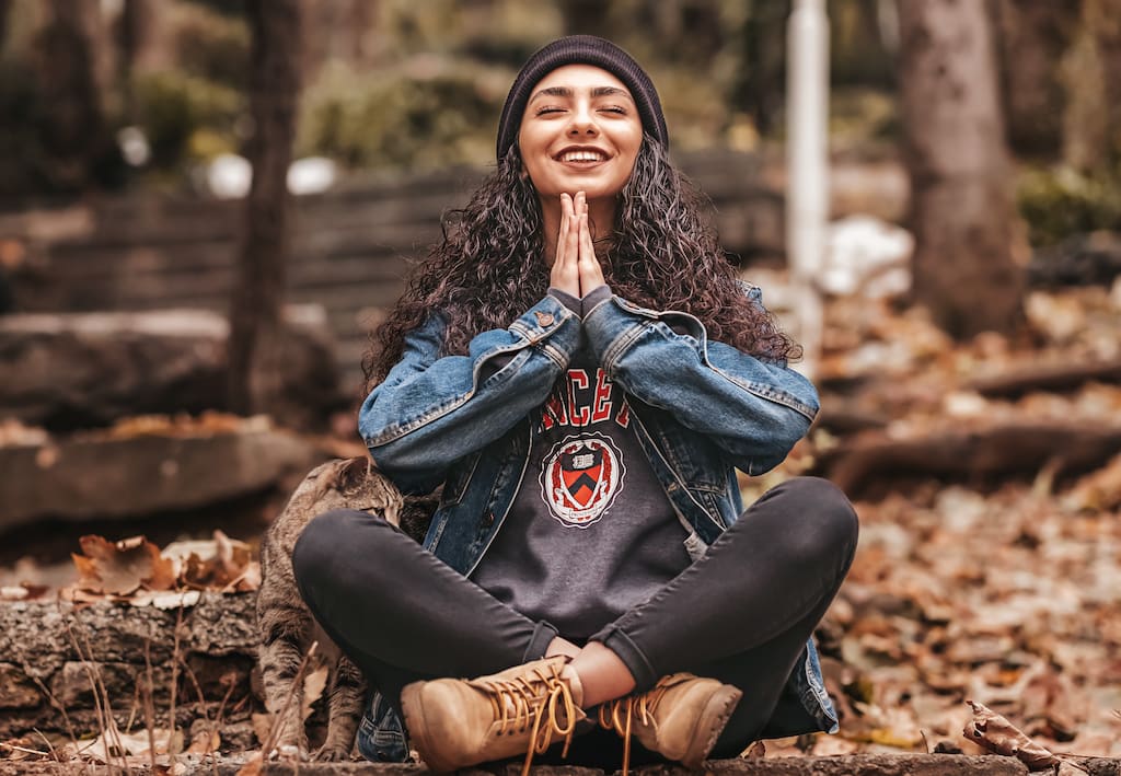 woman smiling and meditating