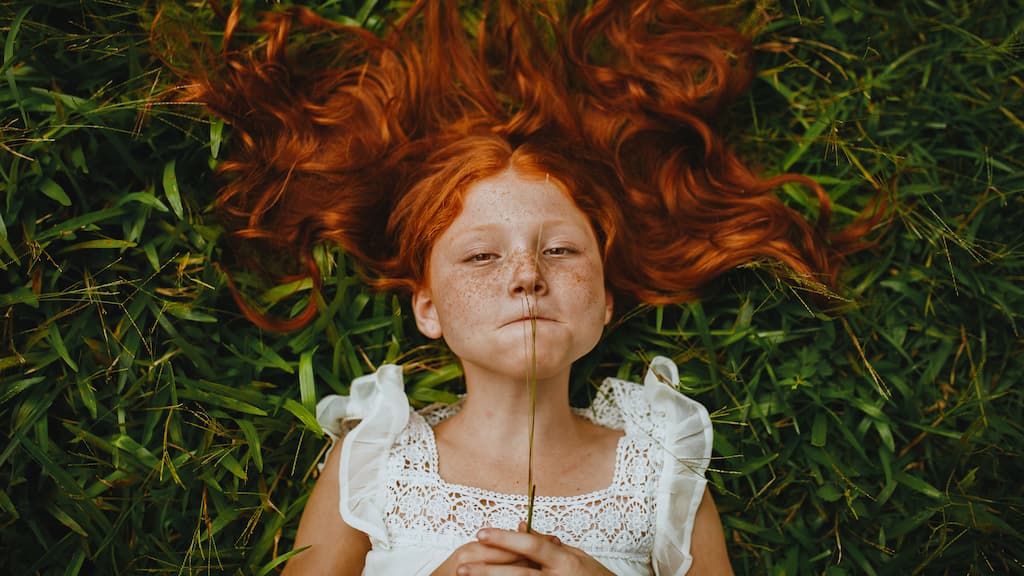 girl lying on the grass