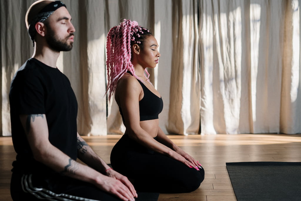 woman and man meditating