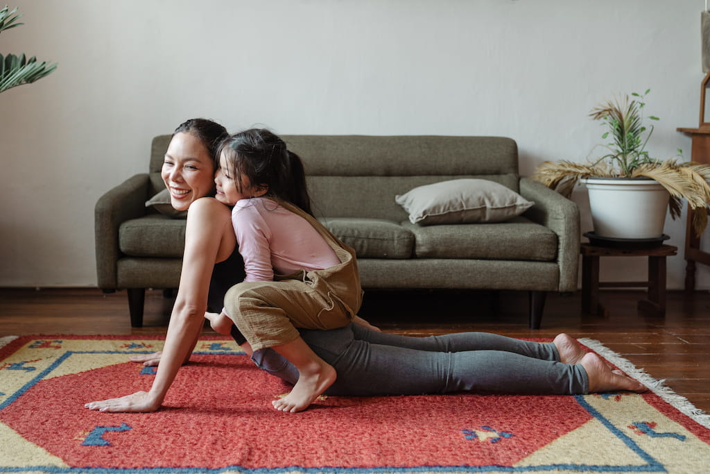 woman doing yoga with a girl