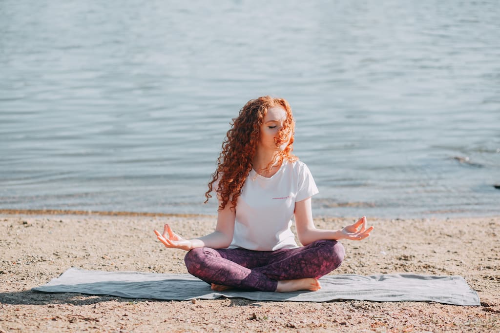 woman meditating on seaside