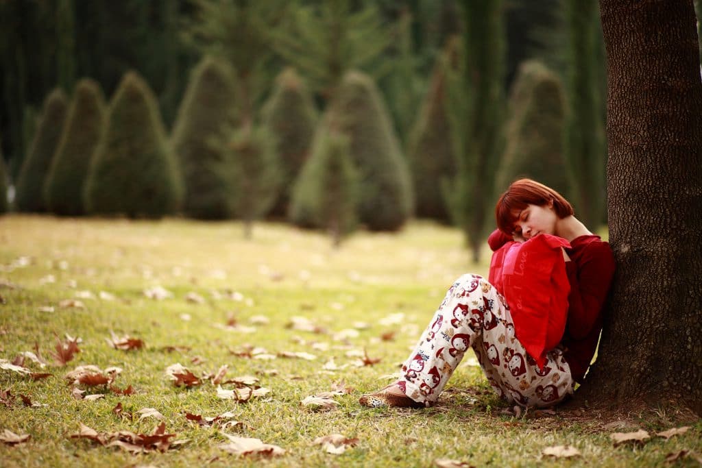 woman sitting in park during autumn